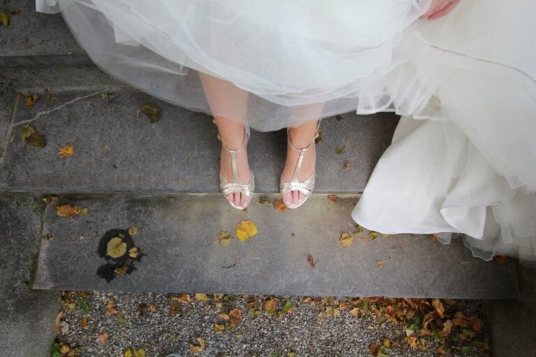 A bride's footwear while she's standing on a stoop